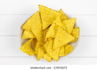 Top-view Of Bowl Filled With Tortilla Chips On White Wooden Surface