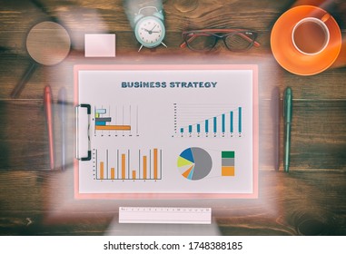 Topview Of Clipboard With Drawing Buisness Strategy On Wooden Table. Business And Startup Concept.