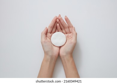 Topview Of Hand Model Holding Cotton Pad In White Background For Cosmetic Advertising