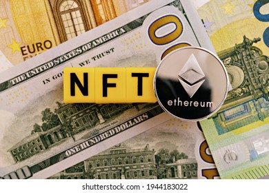 Topview photo on NFT (non-fungible token) theme. Abbreviation NFT and Ethereum blockchain cryptocurrency coin, on the background of dollar and euro banknotes - Shutterstock ID 1944183022