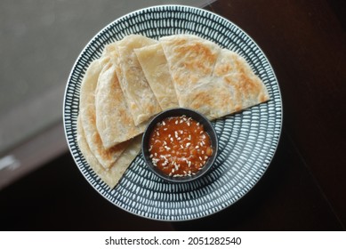 Top-view of Roti serve with peanut sauce in Thai restaurant 