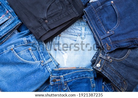 Topview  stack blue jean place on old table in store at supermarket.