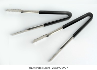 Top-view of stainless steel kitchenware on a white close-up - Shutterstock ID 2365972927