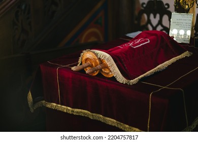 The Torah Scrolls On The Table Covered With Red Cloth And Paper With Hebrew Letters Near It In Synagogue Of Oslo, Norway