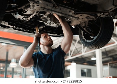 Torch, inspection and mechanic with car in garage for service, maintenance or repair for safety. Light, auto engineering and male industrial worker checking bottom of vehicle for oil leak in workshop - Powered by Shutterstock