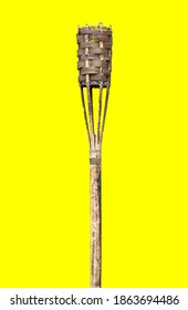 A torch for lighting wooden fire against yellow background 