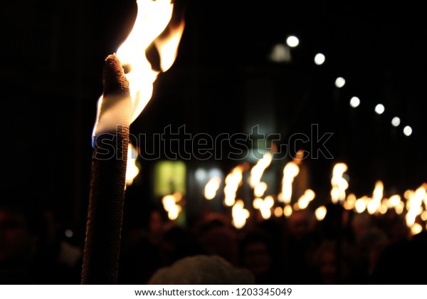Torches at night in a\
procession