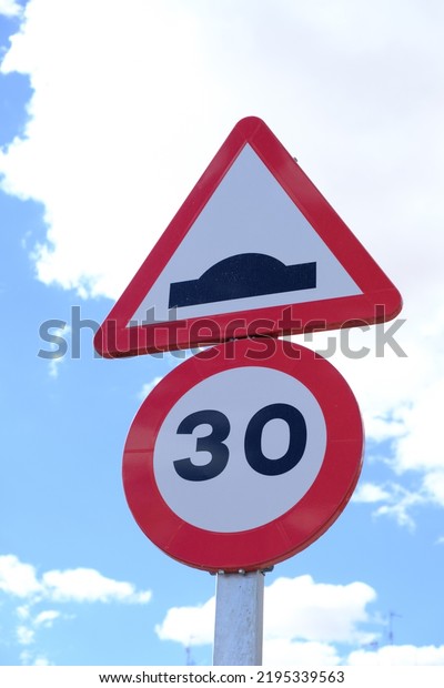 Tordesillas, Spain; August 16 2022: traffic sign\
limiting the maximum speed to 30 kilometers per hour. Speed hump\
sign to reduce speed in urban\
areas