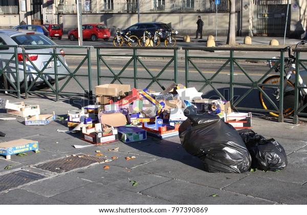 Torino, Italy - January 19, 2018: This is trash in a\
street when the street market in Spezia area closes. Everyday has a\
lot of garbages.  