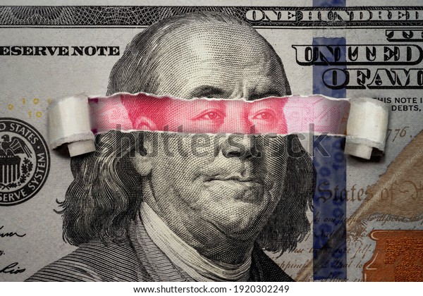 Torn bill revealing Chinese Yuan inside American Dollar. Ideas for Competition between China and USA, Risk of war, Taking over, Economy overtake, Changing world currency from US dollar to Chinese yuan