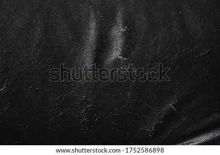 Torn black leather seat included sponge inside. Upholstery, ripped and tear old leather sofa. black leather texture background.