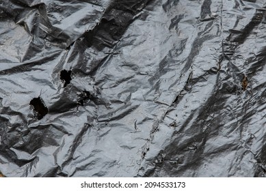 Torn Black Plastic Garbage Bag As A Background.