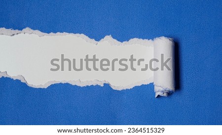 Torn blue paper sheet isolated on white background