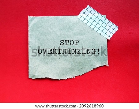 Torn brown paper note with text STOP OVERTHINKING, concept of to remind self to stop thinking too much too long, overcome anxiety and stress, Control negative thoughts - declutter mind and stay focus