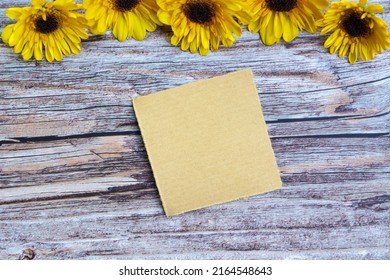 Torn Brown Paper On Wooden Surface And Sunflower Flat Lay With Copy Space.