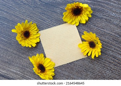 Torn Brown Paper On Wooden Surface And Sunflower Flat Lay With Copy Space.