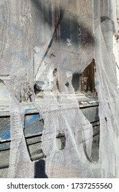 Torn Burlap As Cover For Building On Construction Site. Torn Burlap Background.