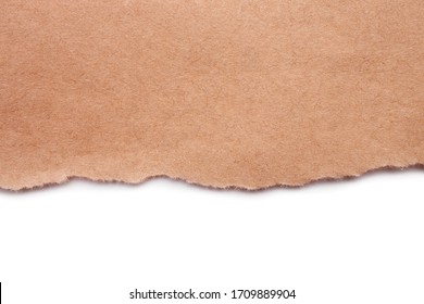 Torn craft paper isolated on white background. Brown paper texture with place for text, top view