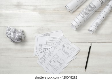 Torn   crumpled sketches lie wooden surface  Top view compositin  Workplace architect constructor  Engineering work  Failure  Construction   architecture  Architect drawing  Exact