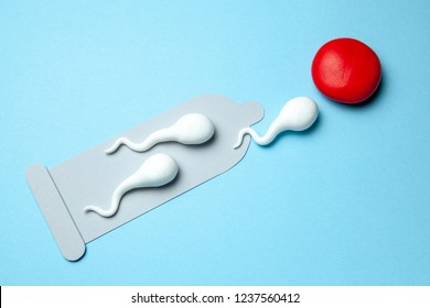 Torn damaged condom and active condoms float to the egg. Unexpected pregnancy, egg fertilization