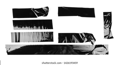 Torn different size black sticky tape, adhesive pieces