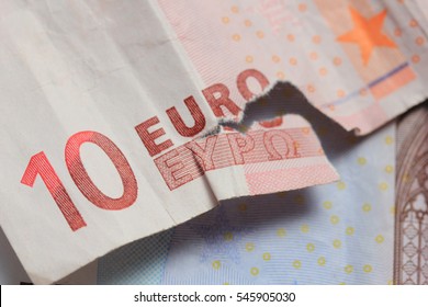 Torn euro note, almost missing the word Euro in Greek characters