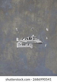 A torn flyer is attached to the wall.