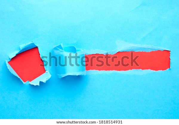 Torn and hole blue paper with space for\
text with red\
background\
\
