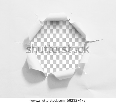 Torn hole and ripped of paper on a transparent background with clipping path.