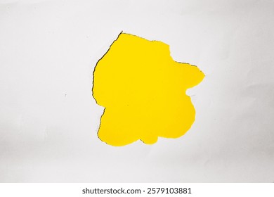 A torn hole in a white paper with a bright yellow background. Perfect for product presentations, branding, and advertising.