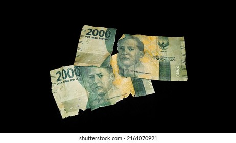 Torn money, old and torn banknote isolated on black background. World finance concept.