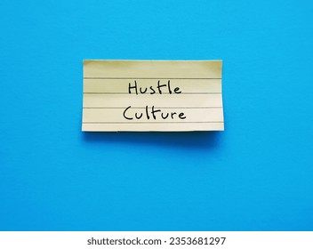 Torn note paper with handwritten text HUSTLE CULTURE - lifestyle where career has become first priority in life, state of constant overworking to the point where it becomes lifestyle