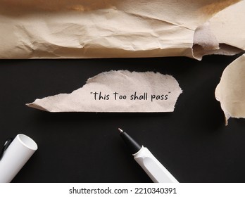 Torn office envelope with handwritten text THIS TOO SHALL PASS, self reminder mantra that nothing, good or bad, lasts forever; all circumstances are temporary - Shutterstock ID 2210340391
