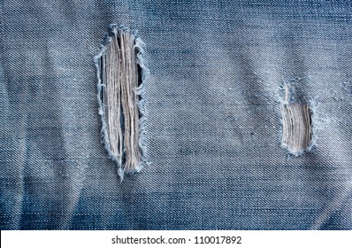torn old blue jeans background