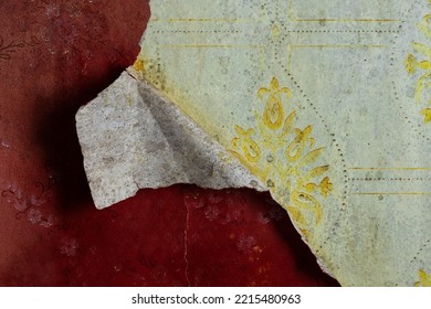 Torn Old Faded Paper Wallpaper With A Retro Pattern. Tattered Scraps Of Paper On The Wall. Vintage Texture For Background And Design. Closeup. High Resolution.