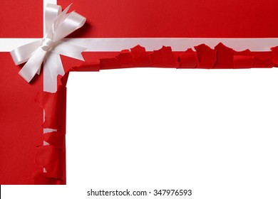 Torn Open Gift, White Ribbon Bow, Red Wrapping Paper Background, Copy Space