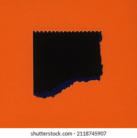 Torn Orange Paper With Black Hole Copy Space