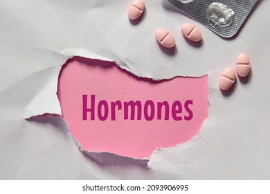 Torn Paper Hole With The Inscription Hormones And Pills. Hormonal Imbalance, Women's Reproductive Health Issues Concept.