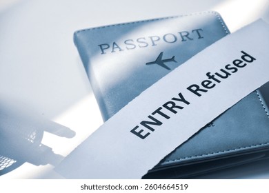 Torn paper with the inscription Entry refused on Passport. Denied entry or entry ban to a country concept, selective focus.