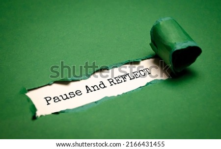Torn paper in the middle of the sheet, inside on a white background the inscription - pause and reflect