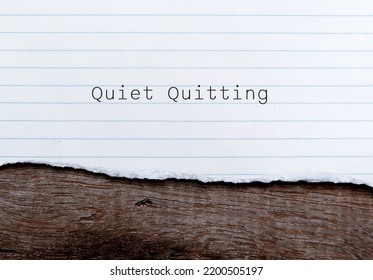 Torn Paper On Wood Background With Words QUIET QUITTING, Workplace Buzzword Of Employees  Limited Tasks, Avoid Working Long Hours, To Set Clear Boundaries To Improve Work Life Balance