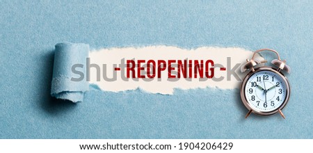 torn paper revealing the word REOPENING on white background