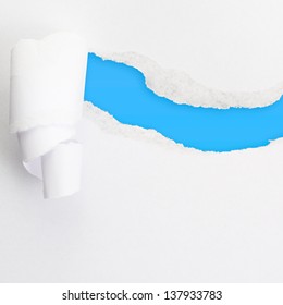 Torn paper sheet with an empty blue colored gap hole as a copyspace background