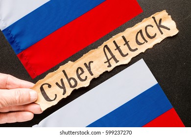 Torn paper with text CYBER ATTACK and the Russian flag