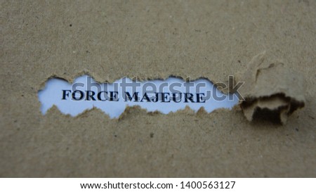 Torn paper with text force majeure. Legal term mean unforeseeable circumstances that prevent someone from fulfilling a contract.