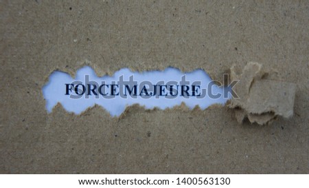 Torn paper with text force majeure. Legal term mean unforeseeable circumstances that prevent someone from fulfilling a contract.