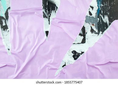 Torn And Peeling Purple Poster Glued On Billboard With Old Dirty Paper. Abstract And Creative Background Of Ripped Purple Glossy Magazine Paper.