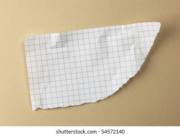 Torn Piece Of Graph Paper On Beige Surface