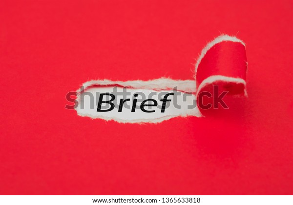 Torn red paper revealing the word Brief.\
Business concept.