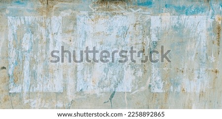 Torn Ripped Aged Paper Poster Street Wall Surface. Blue and White Colors. Leaking Paint. Grunge Rough Dirty Rust Background. Urban Collage Texture. 